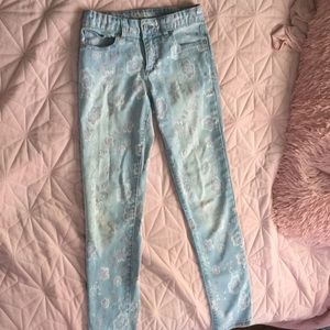 Kids jeans with different prints of flowers.